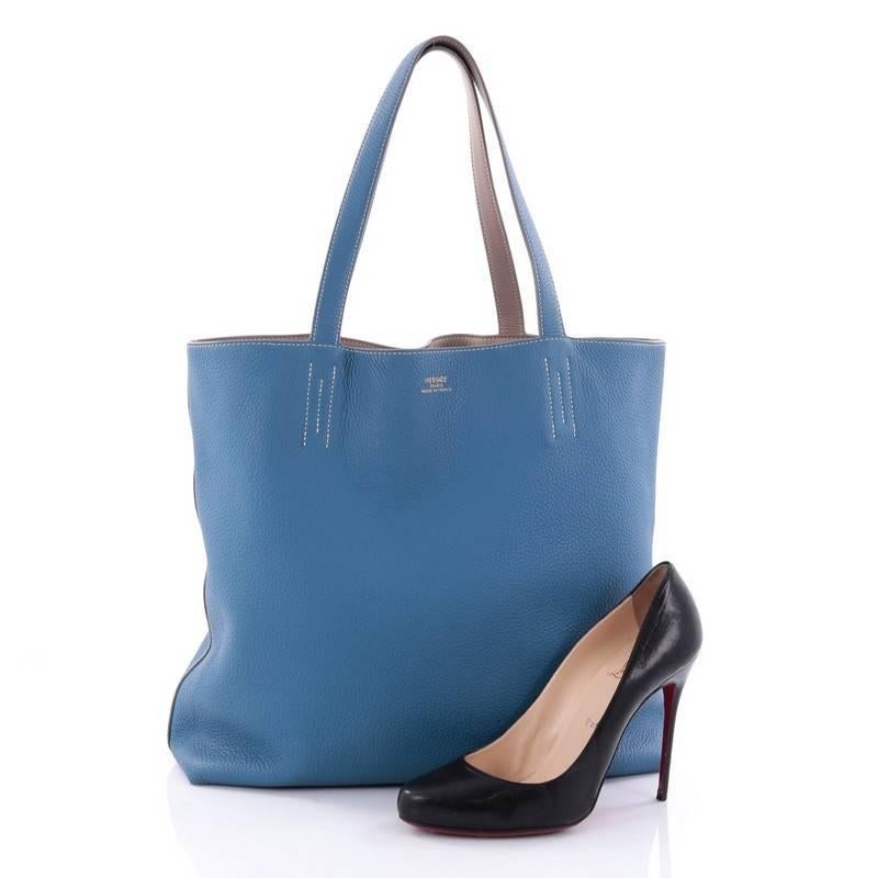 This authentic Hermes Double Sens Tote Clemence 45 combines a simple and functional style from Hermes perfect for everyday use. Crafted from soft luxurious Gris Tourterelle and Bleu Mykonos clemence leather, this versatile tote features dual flat