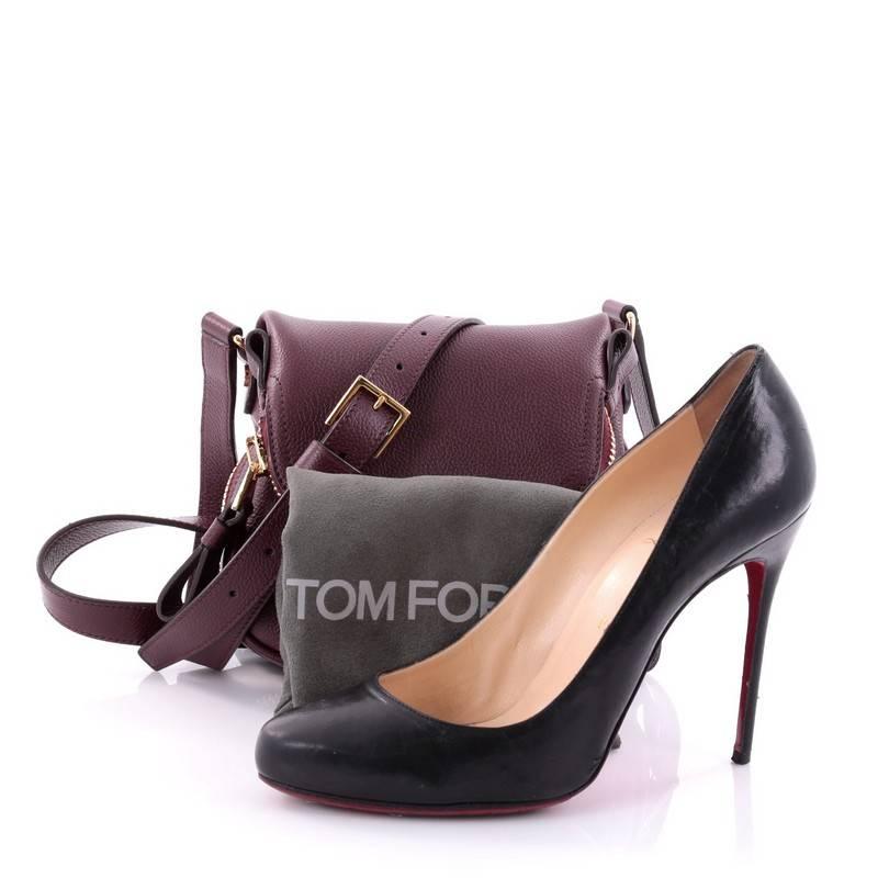 This authentic Tom Ford Jennifer Crossbody Bag Leather Mini redefines modern luxury with timeless elegance. Crafted in burgundy leather, this signature saddle shoulder bag features an adjustable crossbody strap, zip top fold-over flap, expandable