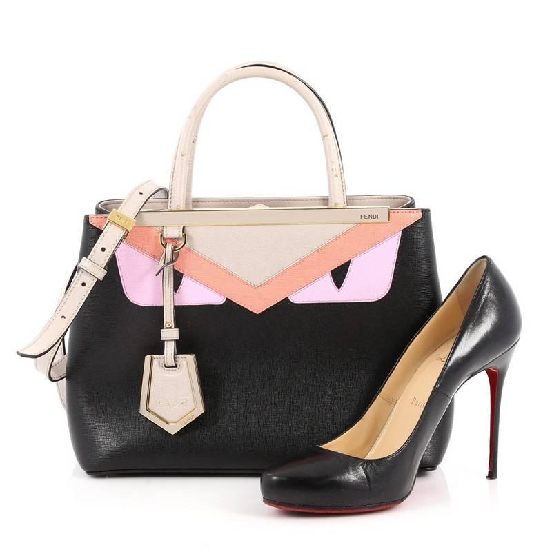 This authentic Fendi 2Jours Monster Handbag Calfskin Petite updates its popular design with an iconic, kitschy monster motif. Crafted from black leather with monster motif to the front, this structured tote features dual-rolled leather handles, a