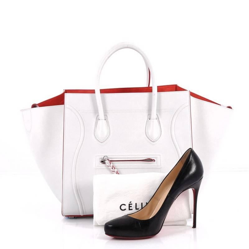 This authentic Celine Phantom Handbag Smooth Leather Medium is one of the most sought-after bags beloved by fashionistas. Crafted from white smooth leather, this minimalist tote features dual-rolled handles, an exterior zip pocket with braided
