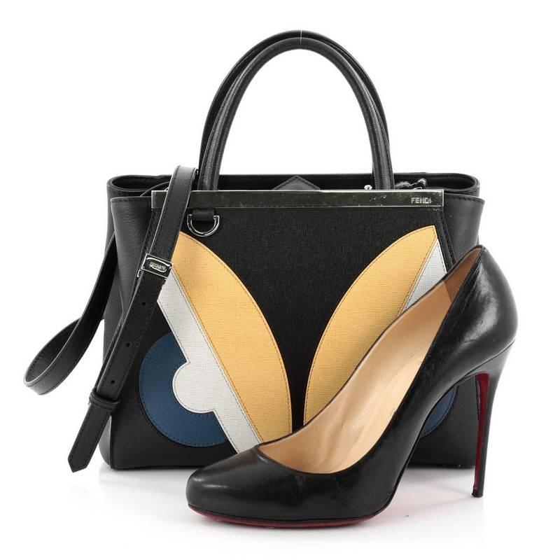 This authentic Fendi 2Jours Monster Handbag Calfskin Petite updates its popular design with an iconic, kitschy monster motif. Crafted from black calfskin leather, this structured tote features dual-rolled leather handles, a shining top bar with