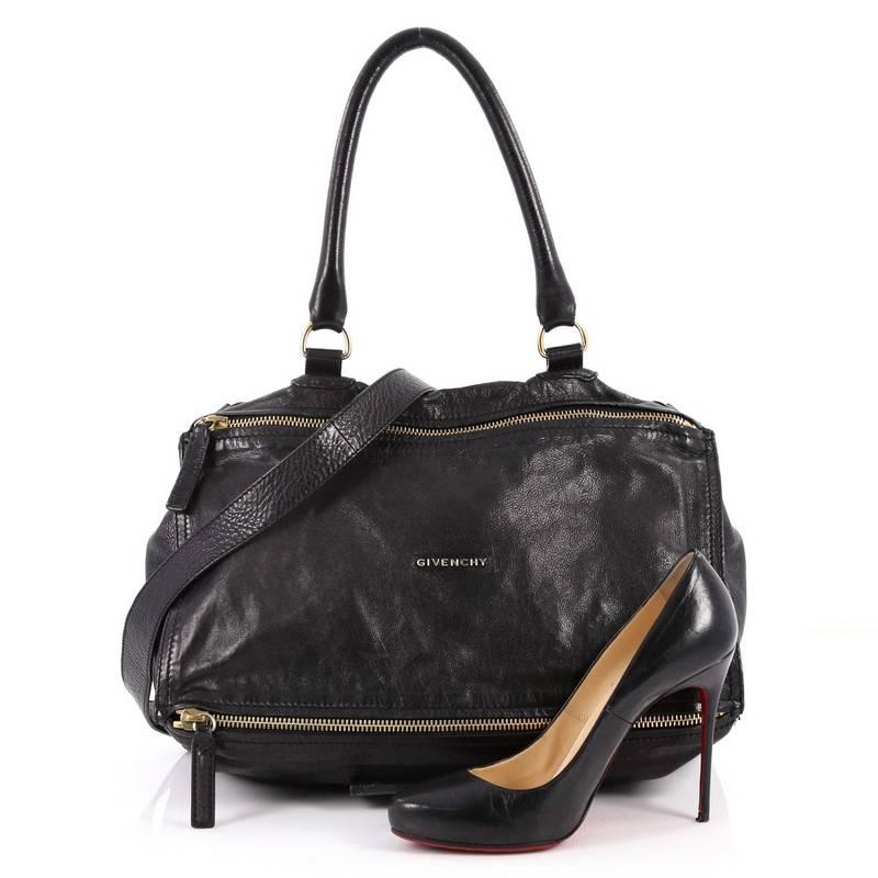 This authentic Givenchy Pandora Bag Leather Large is the perfect companion for any on-the-go fashionista. Crafted in supple black leather, this edgy and cult-favorite satchel features a pandora box-inspired silhouette, a singular top handle, raised