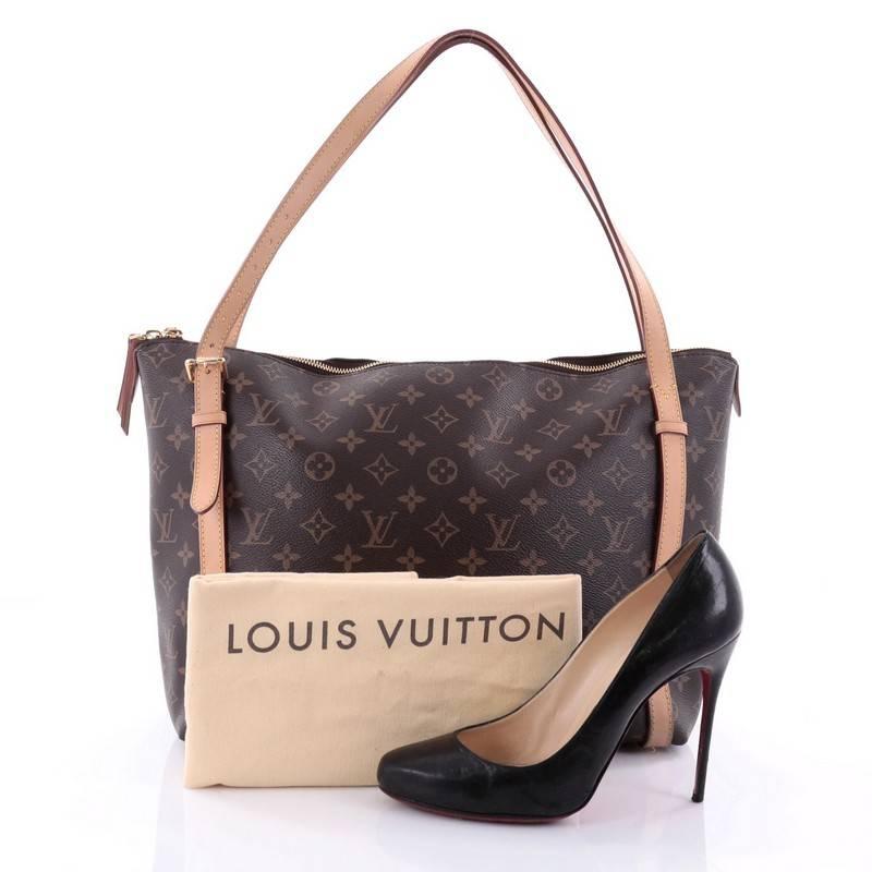 This authentic Louis Vuitton Tuileries Handbag Monogram Canvas is classic and sophisticated in design, perfect for everyday use. Crafted in iconic monogram coated canvas, this luxurious city tote features vachetta leather handles and buckle belted