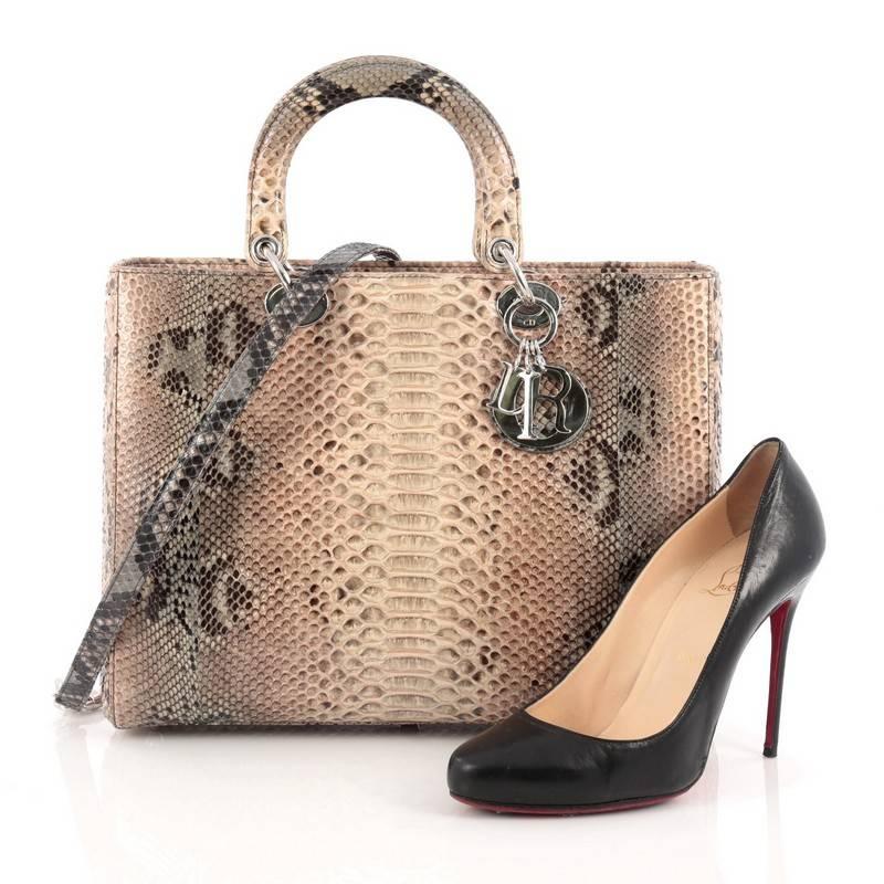 This authentic Christian Dior Lady Dior Handbag Python Large is an elegant and eye-catching piece made for the most daring of fashionistas. Crafted from multicolor genuine python skin, this boxy, large tote features short dual handles, sleek Dior