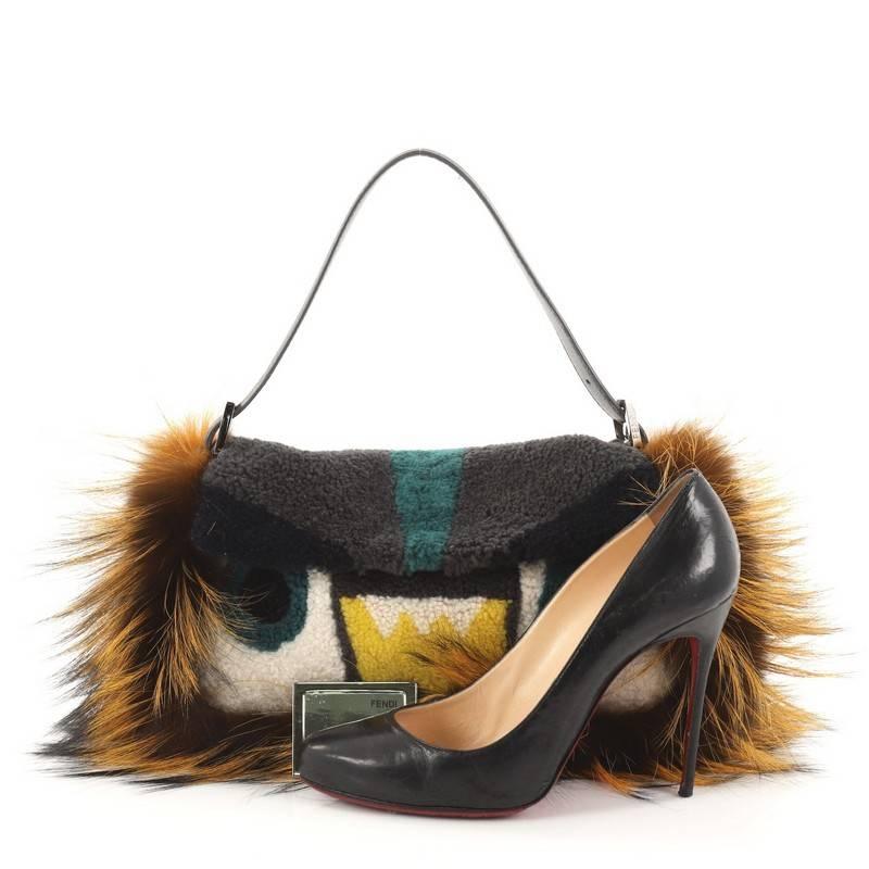 This authentic Fendi Monster Baguette Shearling with Fox Fur is a show-stopping must-have accessory for the boldest of fashionistas. Crafted from gray, white, brown, yellow fur and shearling, this fun and trendy feature Fendi's popular monster