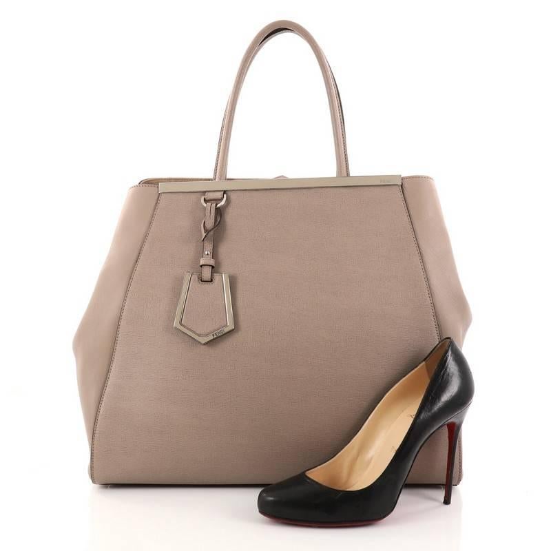 This authentic Fendi 2Jours Handbag Leather Large is an impeccably stylish bag perfect for your everyday looks. Crafted in light taupe textured leather with smooth side wings, this popular tote features dual-rolled leather handles, accented with a