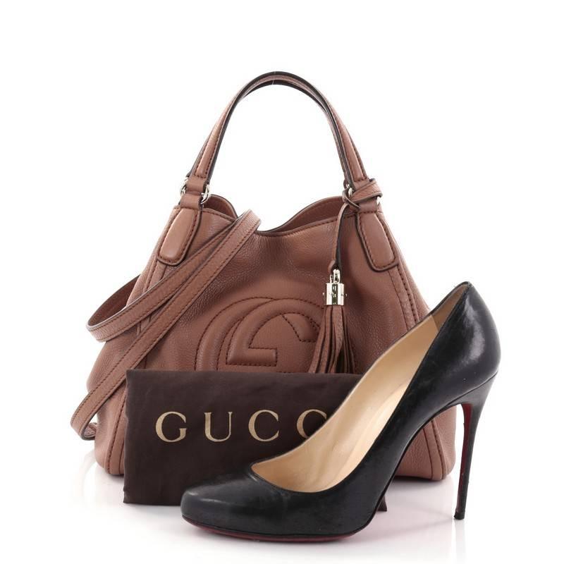This authentic Gucci Soho Convertible Shoulder Bag Leather Small is a fresh, casual-chic tote made for everyday excursions. Crafted from brown leather, this no-fuss tote features Gucci's signature interlocking GG logo stitched at the front, dual
