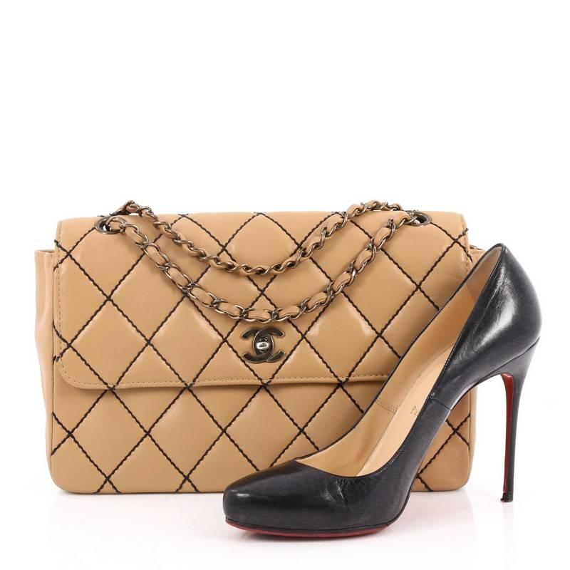 This authentic Chanel Surpique Flap Bag Quilted Leather Jumbo is classic and sophisticated in design, perfect for everyday use. Crafted in beige leather, this bag features woven-in leather chain straps, Chanel's distinct diamond quilted design with