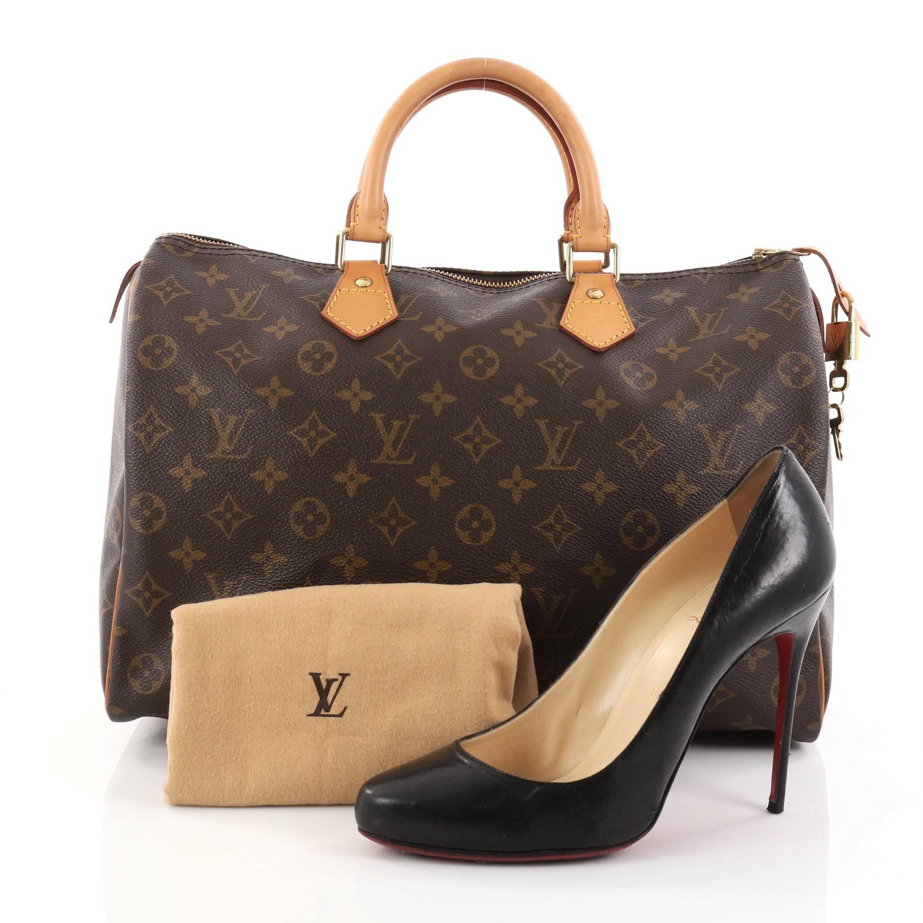 This authentic Louis Vuitton Speedy Handbag Monogram Canvas 35 is a classic must-have, making it ideal for everyday use. Constructed from Louis Vuitton's classic brown monogram coated canvas, this iconic Speedy features dual-rolled vachetta leather
