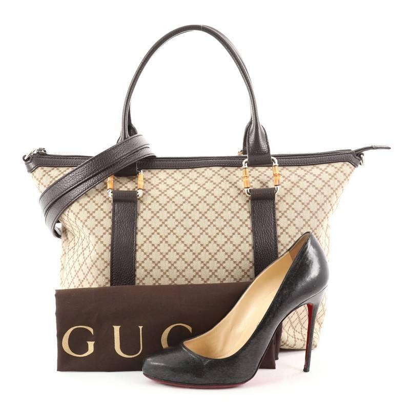 This authentic Gucci Bamboo Convertible Zip Top Tote Diamante Canvas Medium is for everyday casual looks. Crafted in brown diamante canvas with brown leather trim, this chic bag features dual-rolled leather handles with gold and bamboo links,