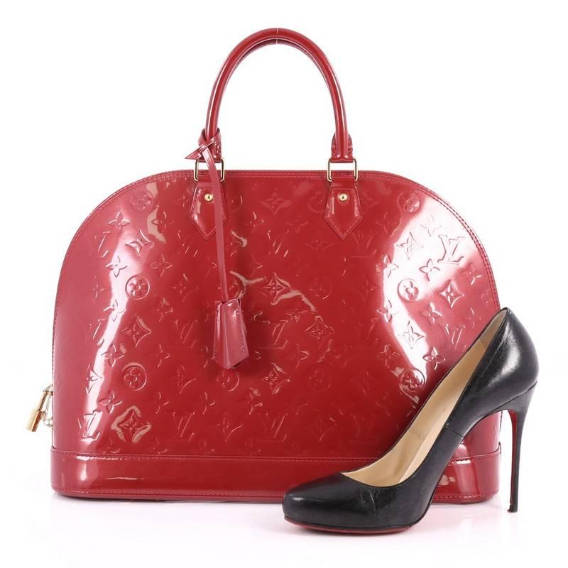 This authentic Louis Vuitton Alma Handbag Monogram Vernis GM is a fresh and elegant spin on a classic style that is perfect for all seasons. Crafted from Louis Vuitton's red monogram vernis leather, this dome-shaped satchel features dual-rolled