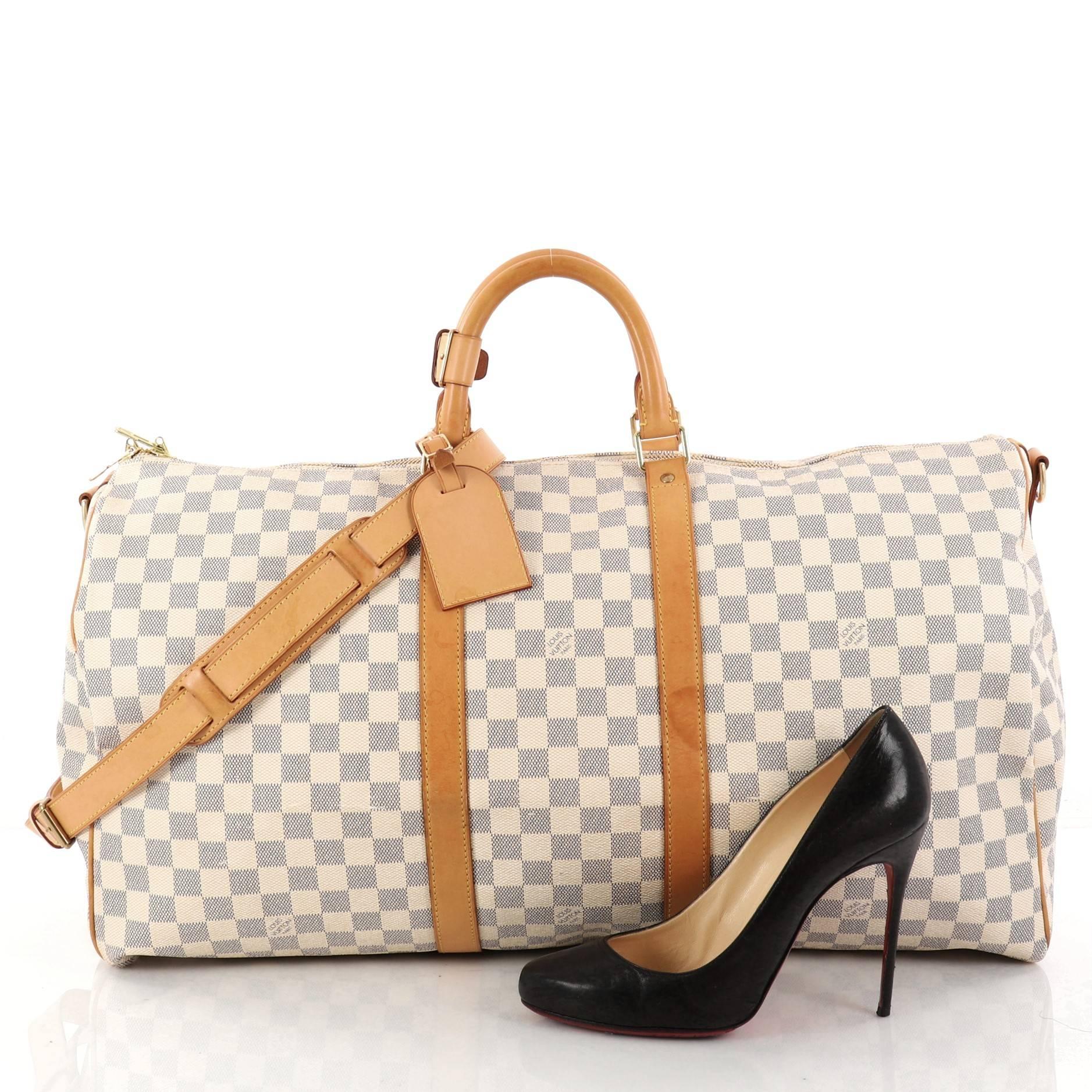 This authentic Louis Vuitton Keepall Bandouliere Bag Damier 55 is the perfect purchase for a weekend trip, and can be effortlessly paired with any outfit from casual to formal. Crafted with traditional damier azur coated canvas, this classic