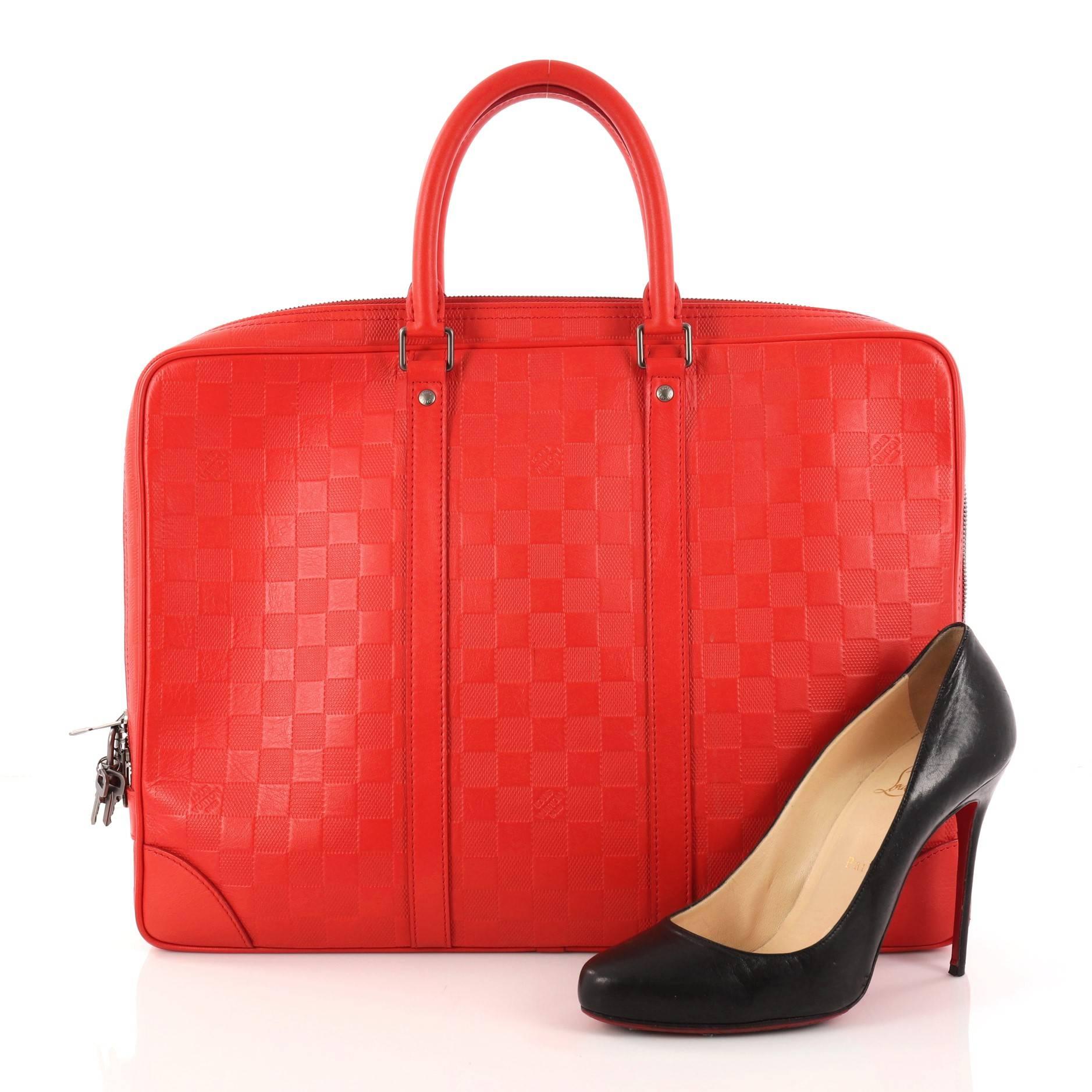 This authentic Louis Vuitton Porte-Documents Voyage Briefcase Damier Infini Leather updates its traditional men's briefcase with a luxurious and urban spin. Crafted in eye-catching design red damier infini leather, this functional contemporary bag