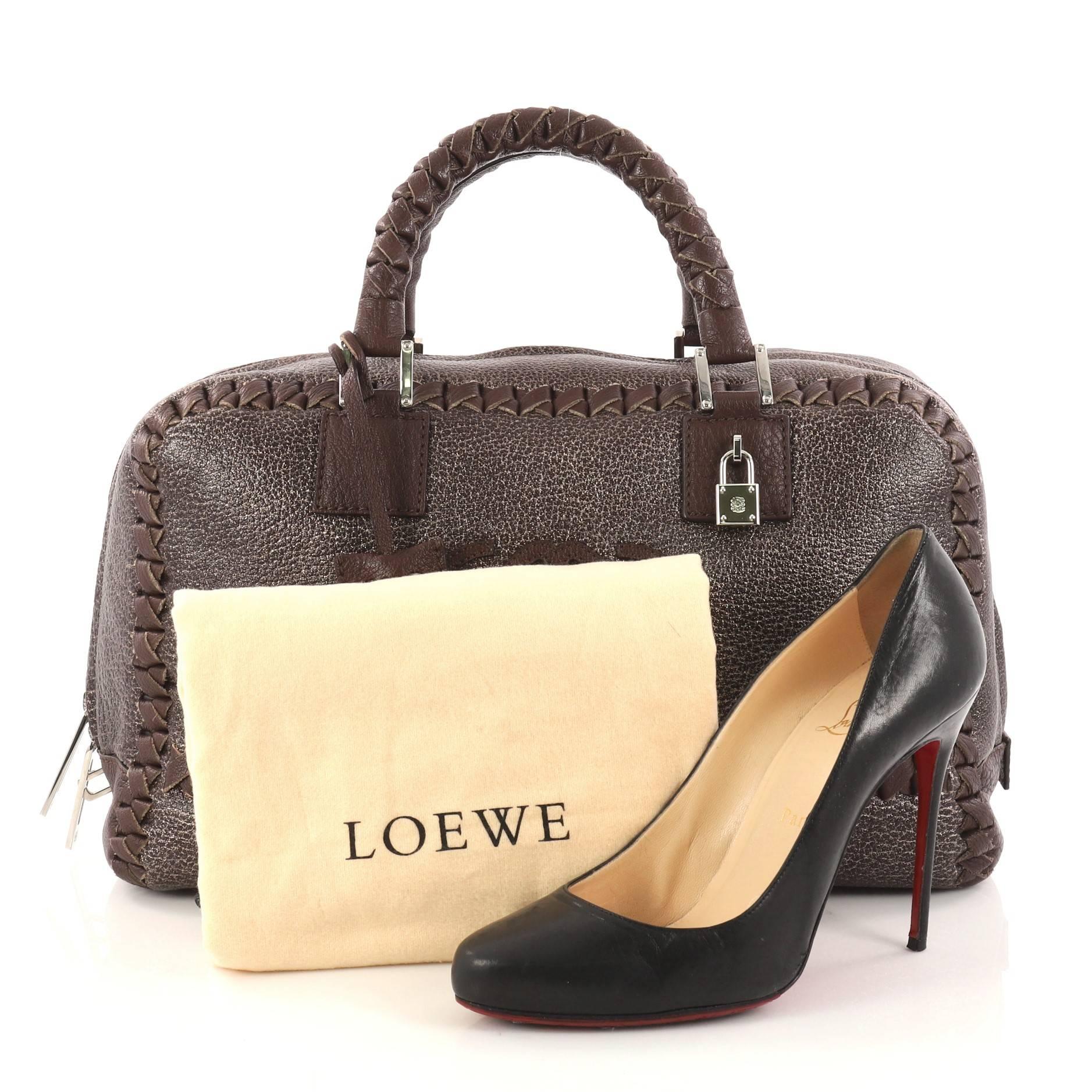 This authentic Loewe Amazona Bag Whipstitch Leather 36 is a perfect minimalist handbag for on-the-go fashionista. Crafted in dark brown leather, this bag features dual-braided leather handles, whipstitched leather trims, stitched logo at front,