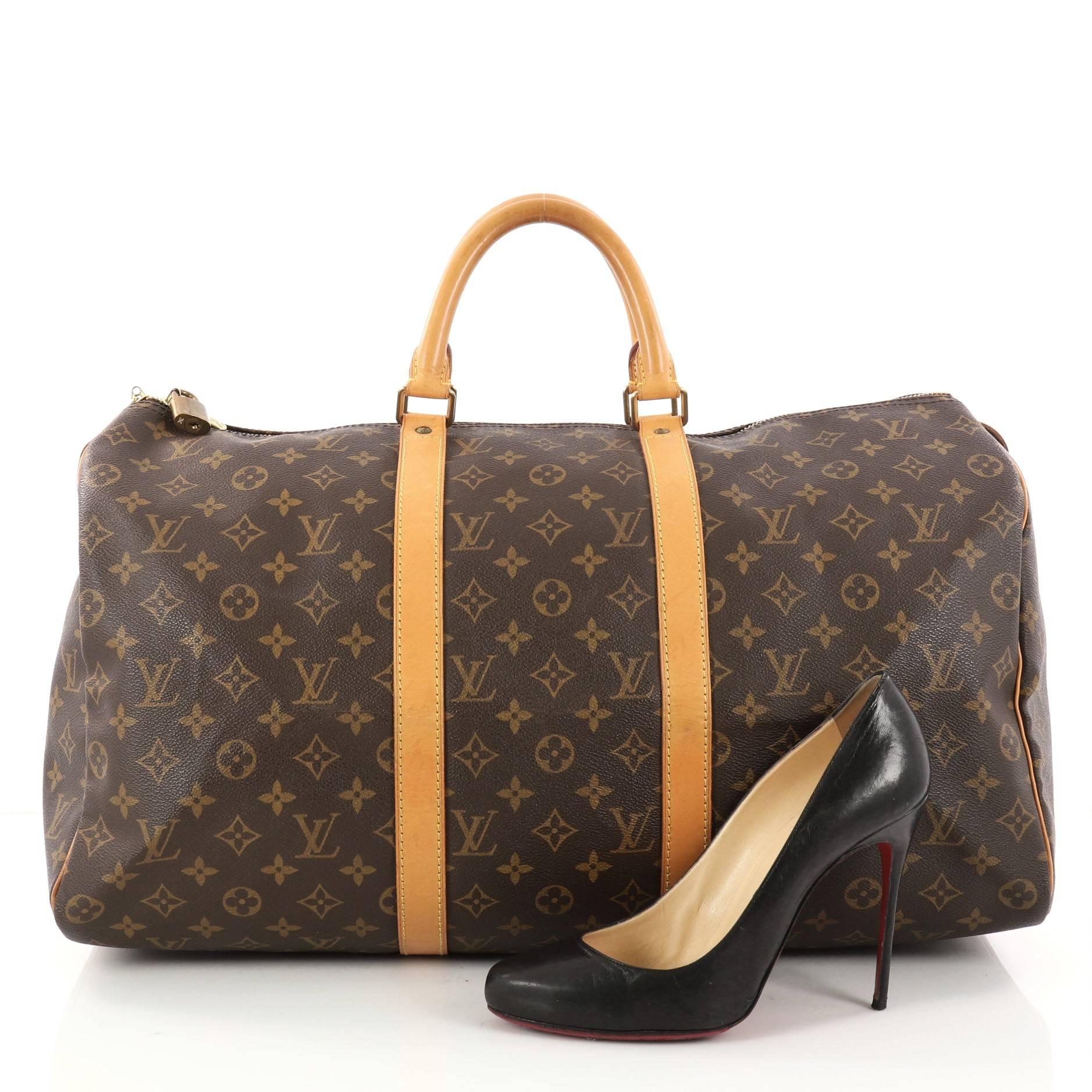 This authentic Louis Vuitton Keepall Bag Monogram Canvas 50 is the perfect purchase for a weekend trip, and can be effortlessly paired with any outfit from casual to formal. Crafted from traditional brown monogram coated canvas, this luxurious