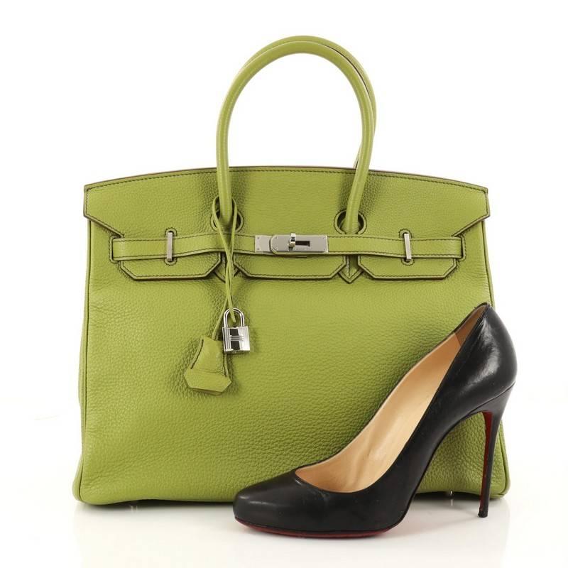 This authentic Hermes Birkin Handbag Vert Anis Togo with Palladium Hardware 35 stands as one of the most-coveted and timeless bags fit for any fashionista. Constructed from scratch-resistant Vert Anis togo leather, this subtly sleek tote features