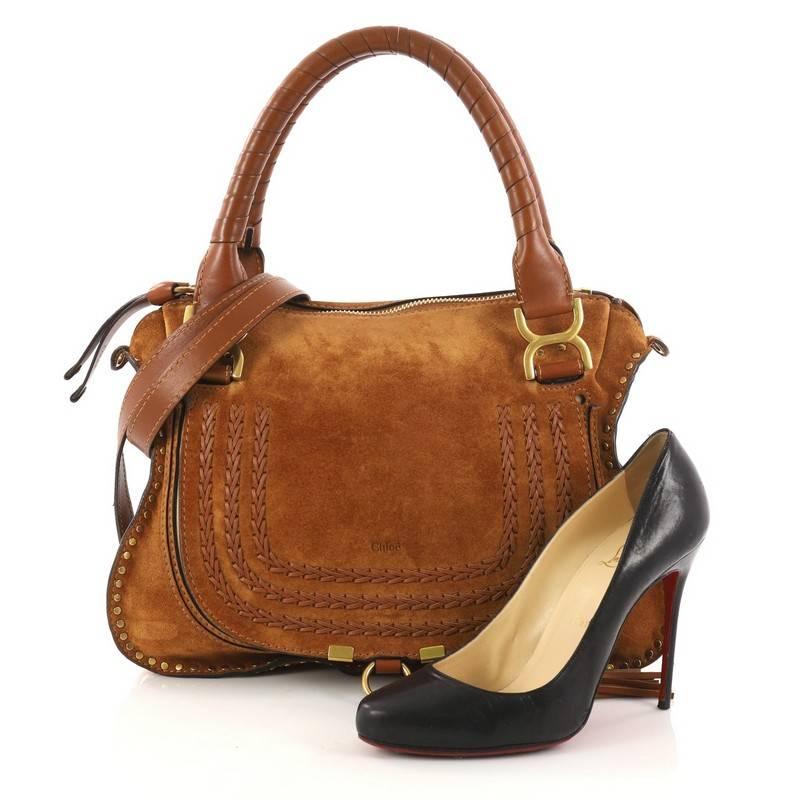 This authentic Chloe Marcie Satchel Whipstitch Studded Suede Medium showcases the brand's popular horseshoe design. Constructed from brown suede, this functional yet stylish satchel features a slouchy, easy-to-carry silhouette, wrapped leather