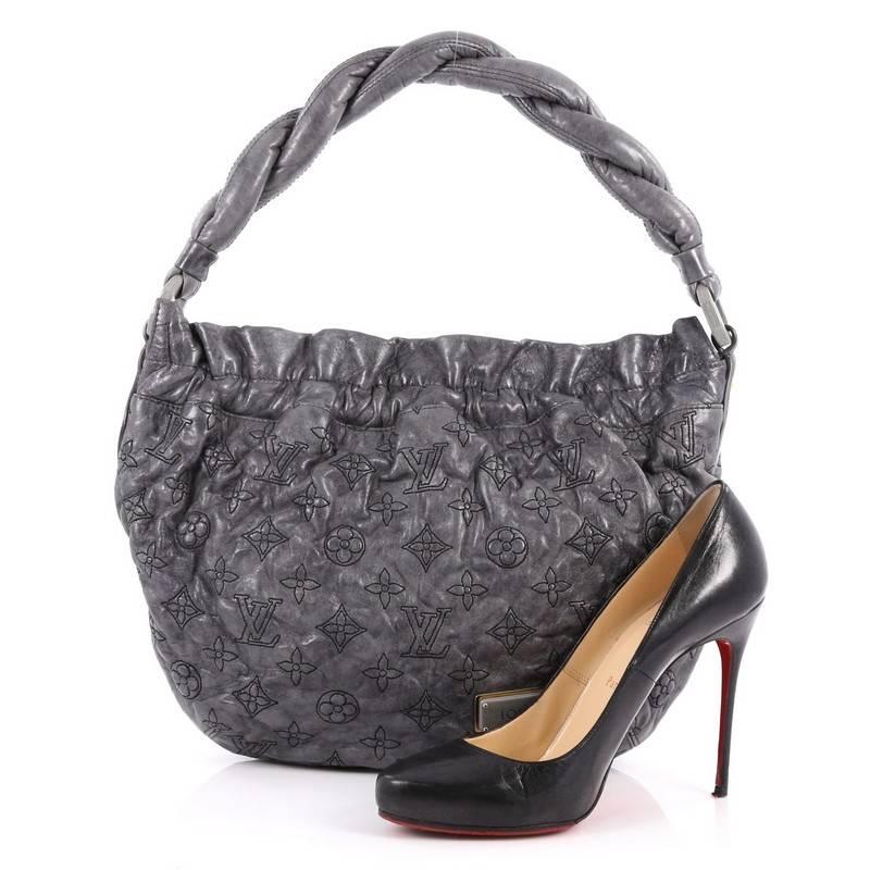 This authentic Louis Vuitton Olympe Nimbus Handbag Limited Edition Monogram Lambskin PMM, inspired by cloudy Mount Olympus, is a feminine and chic bag with intricately stitched monogram detailing. Crafted from grey monogram lambskin leather, this
