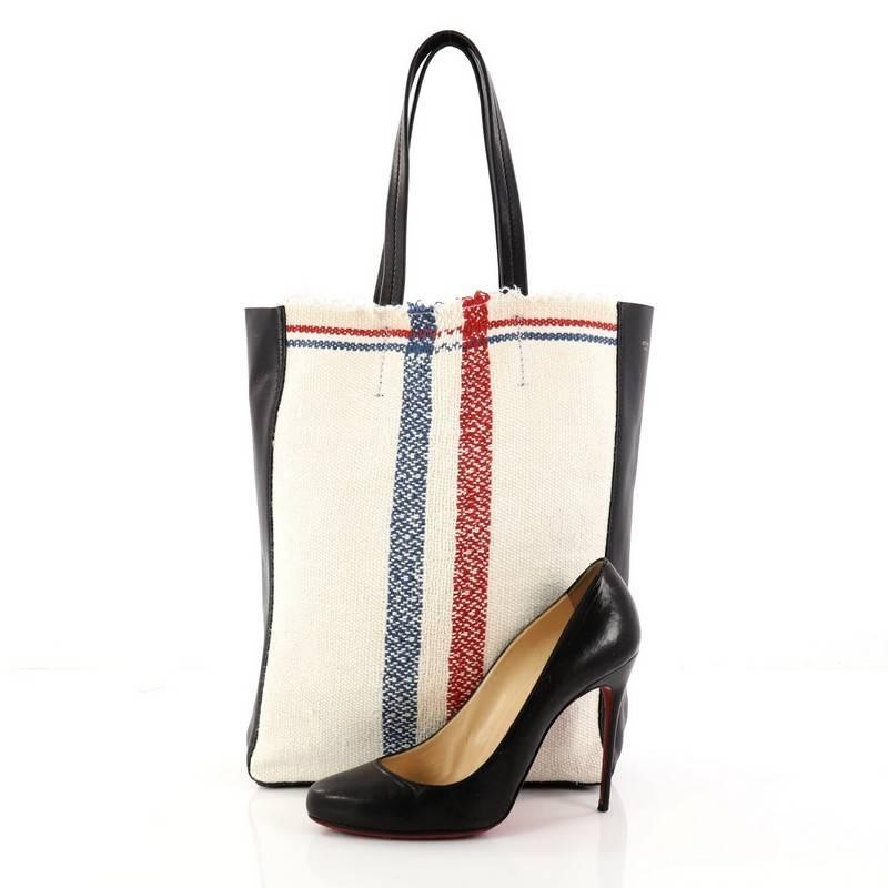 This authentic Celine Cabas Tote Woven Cotton is the perfect everyday shopper bag holding all essentials. Crafted in navy leather and woven cotton, this tote features dual slim leather handles, and gold-tone hardware accents. Its spacious leather