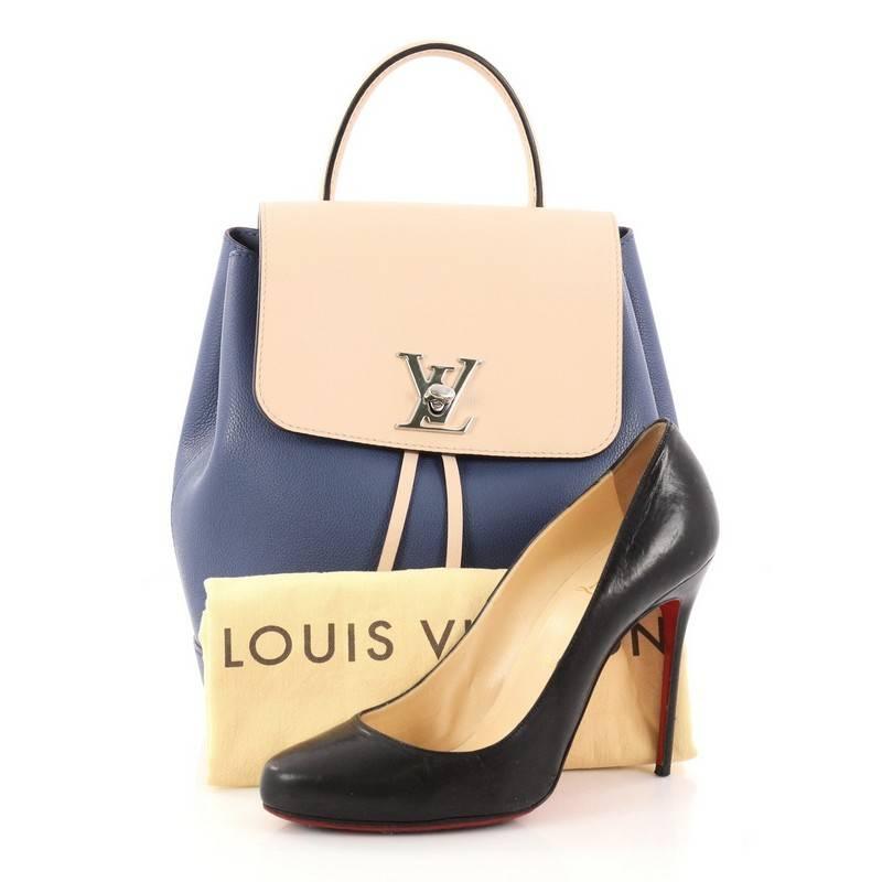 This authentic Louis Vuitton Lockme Backpack Leather is a youthful daily companion for the active fashionista. Crafted in blue and nude leather, this chic backpack features a leather top handle, adjustable should straps, LV logo turn lock and