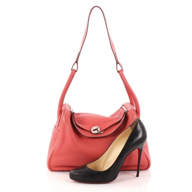 This authentic Hermes Lindy Handbag Clemence 30 is the perfect understated accessory for the modern woman. Crafted from Bougainvillea clemence leather, this no-fuss shoulder bag features dual rolled handles, two sides slip pockets, protective base