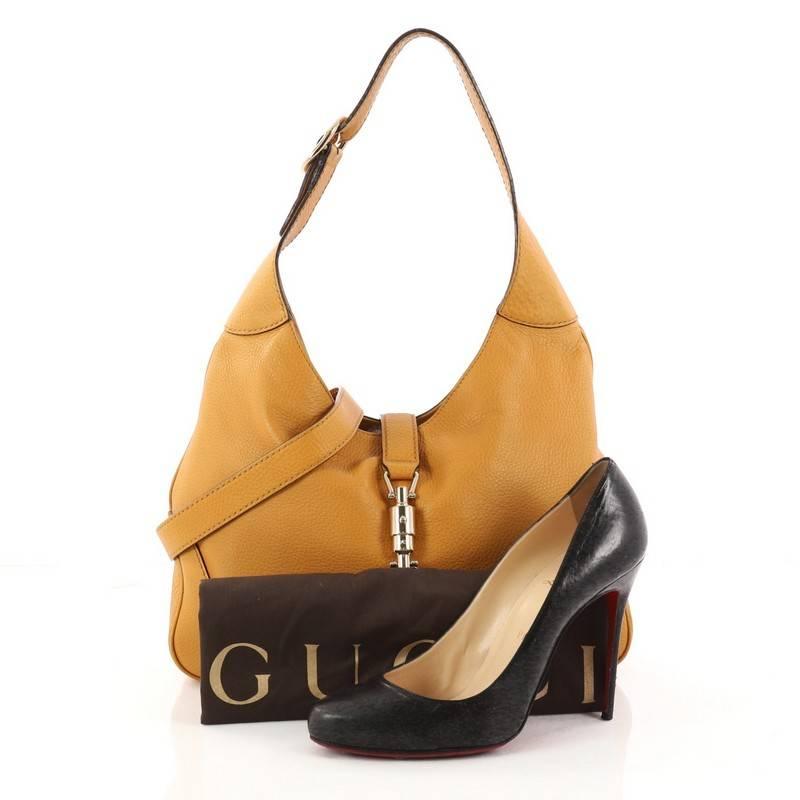 This authentic Gucci Jackie Original Shoulder Bag Leather Medium is a must-have luxurious everyday shoulder bag fit for the modern woman. Crafted from mustard leather, this re-imagined Jackie shoulder bag features an adjustable shoulder strap with