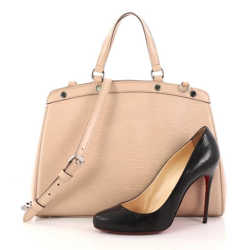 This authentic Louis Vuitton Brea Handbag Epi Leather MM is a staple for an everyday casual look. Crafted from nude epi leather, this structured yet feminine tote features dual flat leather handles, engraved LV studs, subtle logo, protective base