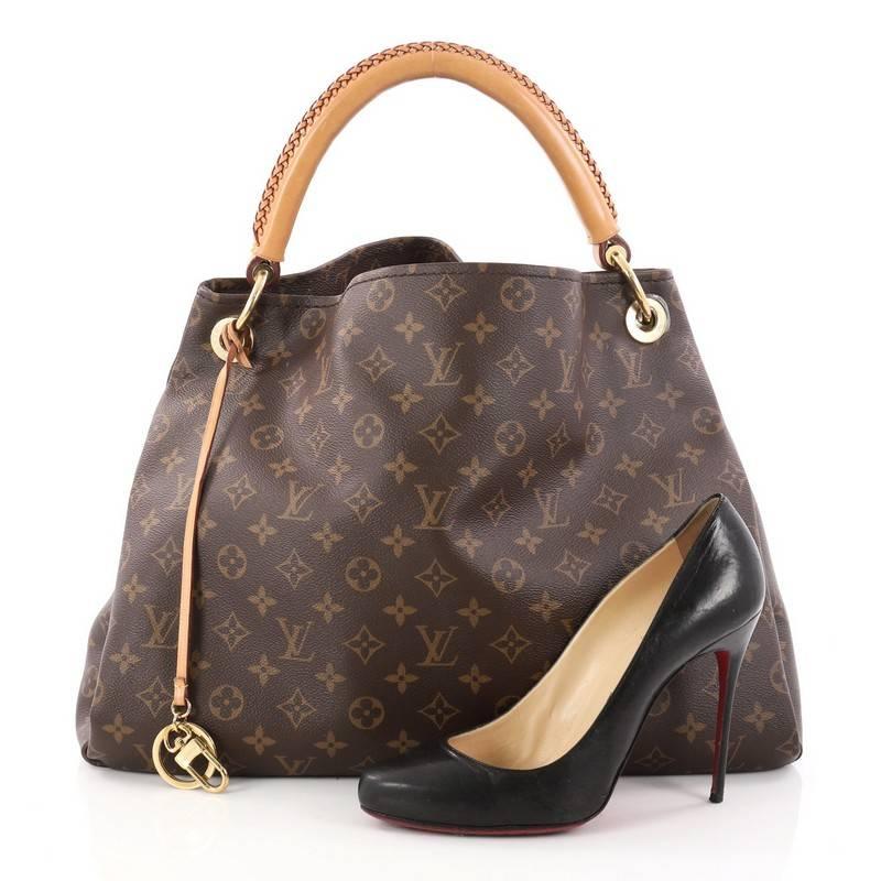 This authentic Louis Vuitton Artsy Handbag Monogram Canvas MM is an elegant and iconic bag that adds a stylish flair to any outfit. Crafted from Louis Vuitton's iconic brown monogram coated canvas, this roomy Artsy hobo features a rolled leather