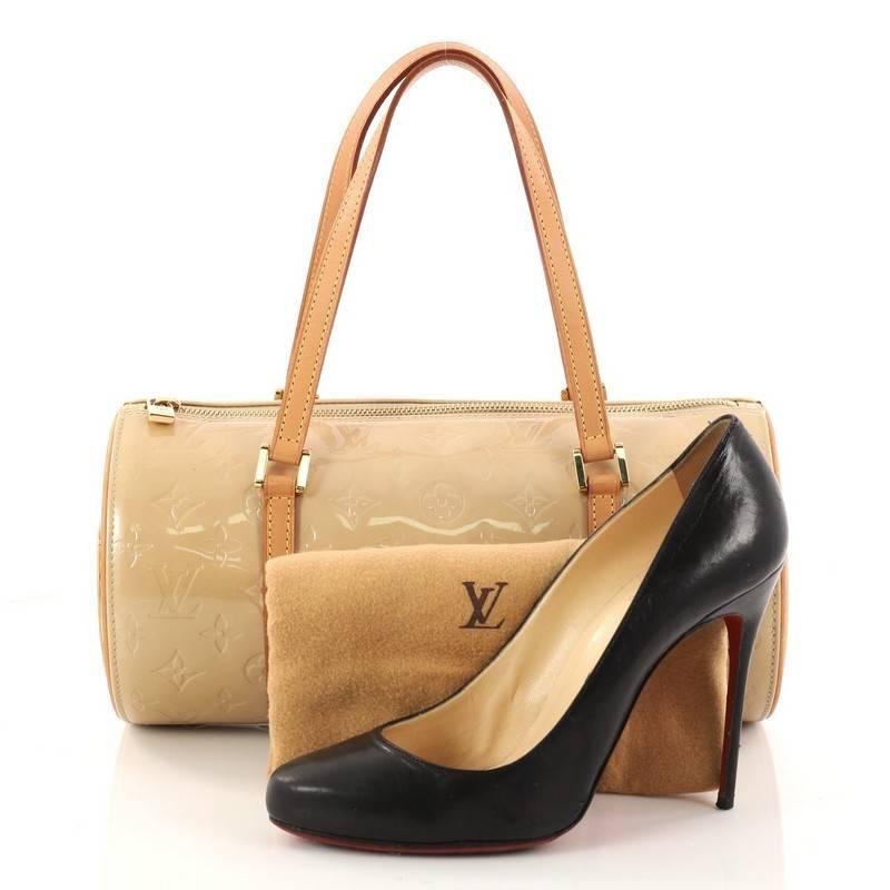 This authentic Louis Vuitton Bedford Handbag Monogram Vernis is a fabulous bag for any fashionista on-the-go. Crafted from beige monogram vernis leather, this stunning bag features dual-flat leather handles, vachetta leather trims, classic rounded