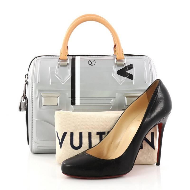 This authentic Louis Vuitton Speedy Handbag Printed Embossed Leather 25 from 2017 is a gorgeous and futuristic bag that's sure to be a head turner. Crafted in silver printed calf leather with embossed tight lines and streamlined-shape, this