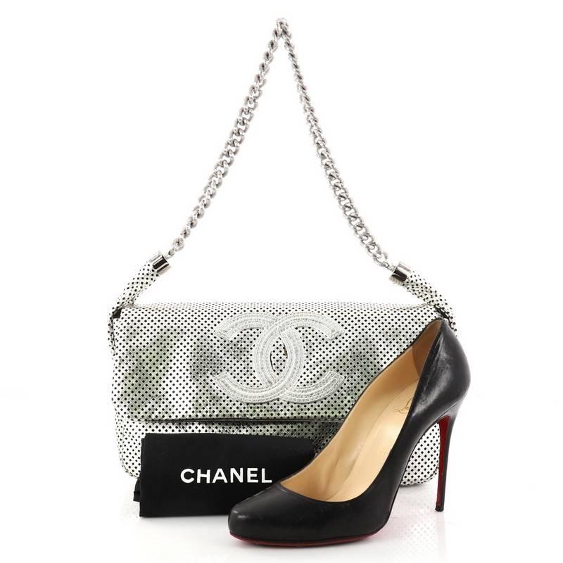 This authentic Chanel Rodeo Drive Flap Bag Perforated Leather Medium is an elegant and stylish bag perfect for your day to night looks. Crafted in silver perforated leather, this chic bag features chain-link shoulder strap, large CC stitched logo on