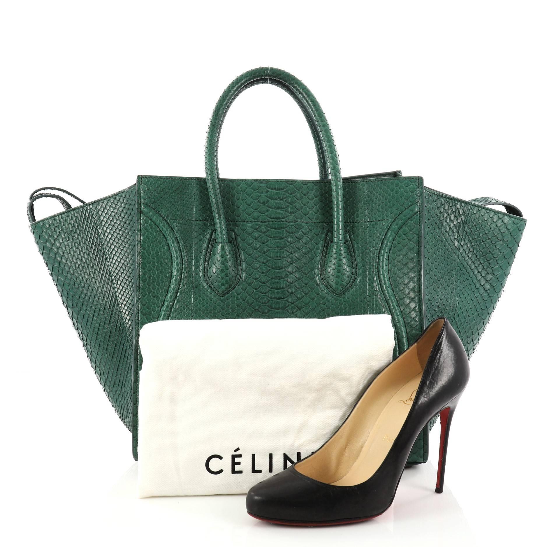 This authentic Celine Phantom Handbag Python Medium by Phoebe Philo mixes classic minimalist Celine style with casual luxe detailing. Crafted from genuine green python skin, this ultra-chic bag features exterior front zip pocket with braided zipper