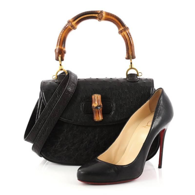 This authentic Gucci Vintage Bamboo Convertible Top Handle Bag Ostrich Medium is unmistakably a classic Gucci design. Crafted from genuine black ostrich skin, this iconic satchel features a looped bamboo top handle, bamboo turn-lock closure, and