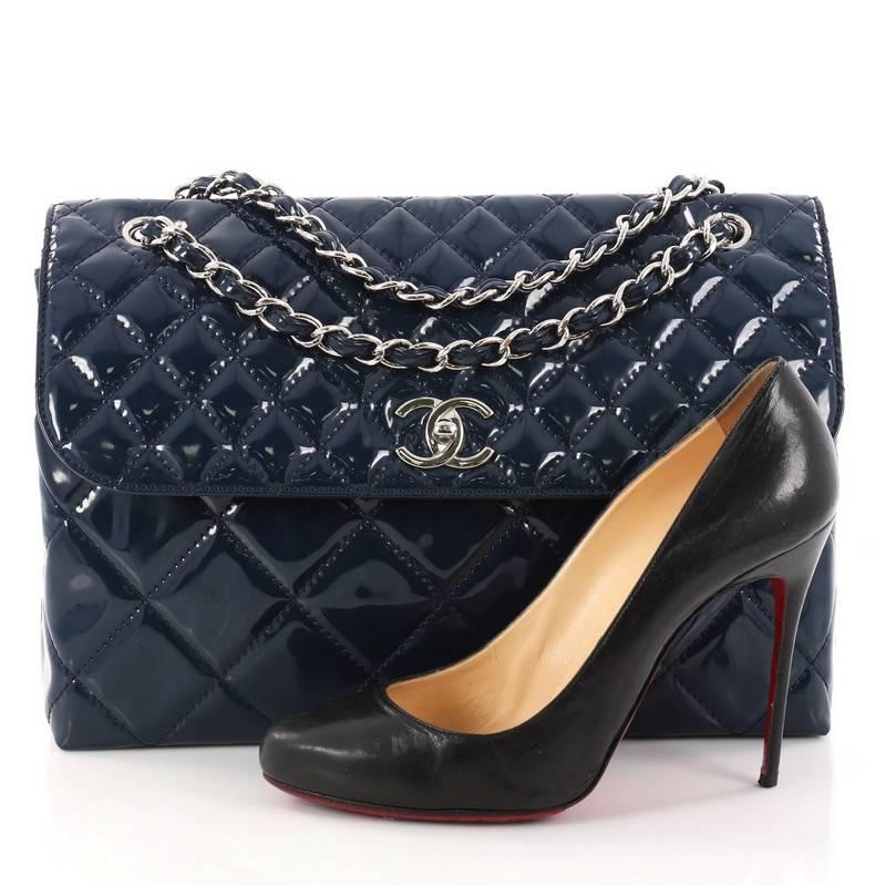 This authentic Chanel In The Business Flap Bag Quilted Patent Vinyl Maxi is a marvelous bag for day or evening looks. Crafted from glossy black patent vinyl, this timeless flap bag features woven-in vinyl chain strap, exterior back pocket, and