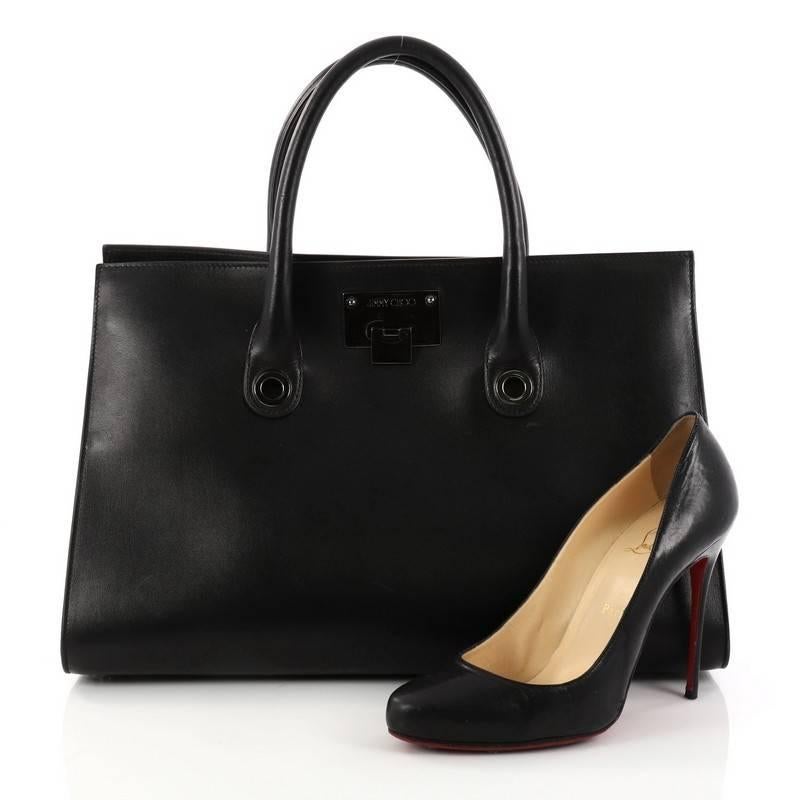 This authentic Jimmy Choo Riley Tote Leather Largee is an easy to carry bag that adds a touch of sophistication on your everyday outfits. Crafted from black leather, this bag features dual-rolled leather handles, subtle suede side gussets,