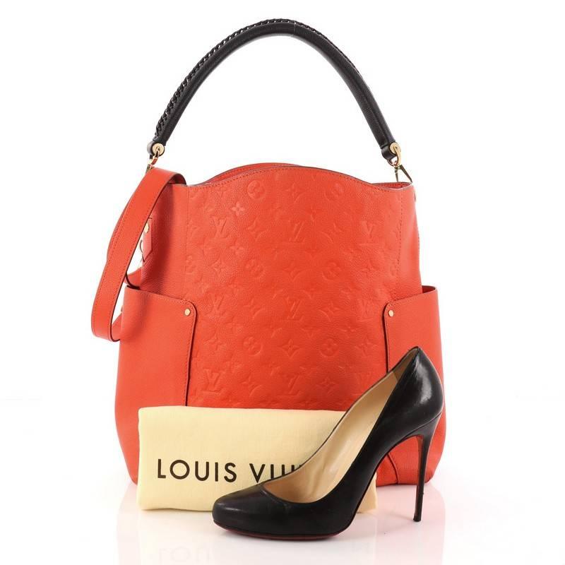 This authentic Louis Vuitton Bagatelle Hobo Monogram Empreinte Leather is a versatile and chic bag perfect for your everyday looks. Crafted from orange monogram empreinte leather, this luxurious hobo features a braided handle, removable long
