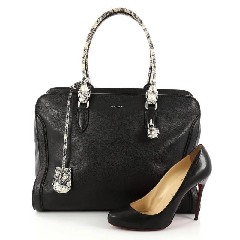 This authentic Alexander McQueen Padlock Zip Around Tote Leather Medium is a sleek and stylish accessory made for every fashionista. Crafted in black leather, this functional tote features dual-rolled handles, defined edges, signature silver skull