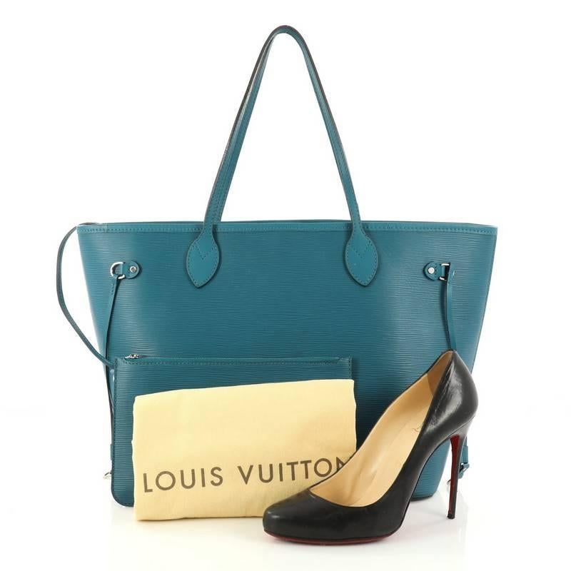 This authentic Louis Vuitton Neverfull Tote Epi Leather MM is a perfect companion for daily excursions. Crafted in teal epi leather, this iconic, easy-to-carry tote features dual flat leather handles, side tassels that cinch and expand, and