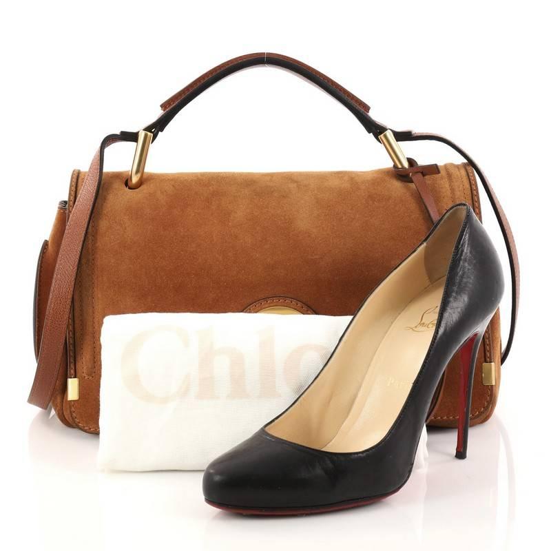 This authentic Chloe Indy Double Carry Bag Suede Small is a practical everyday bag that displays a laid-back elegance. Crafted in brown suede, this chic bag features a suede top handle, exterior back flat pocket with snap closure, exaggerated round