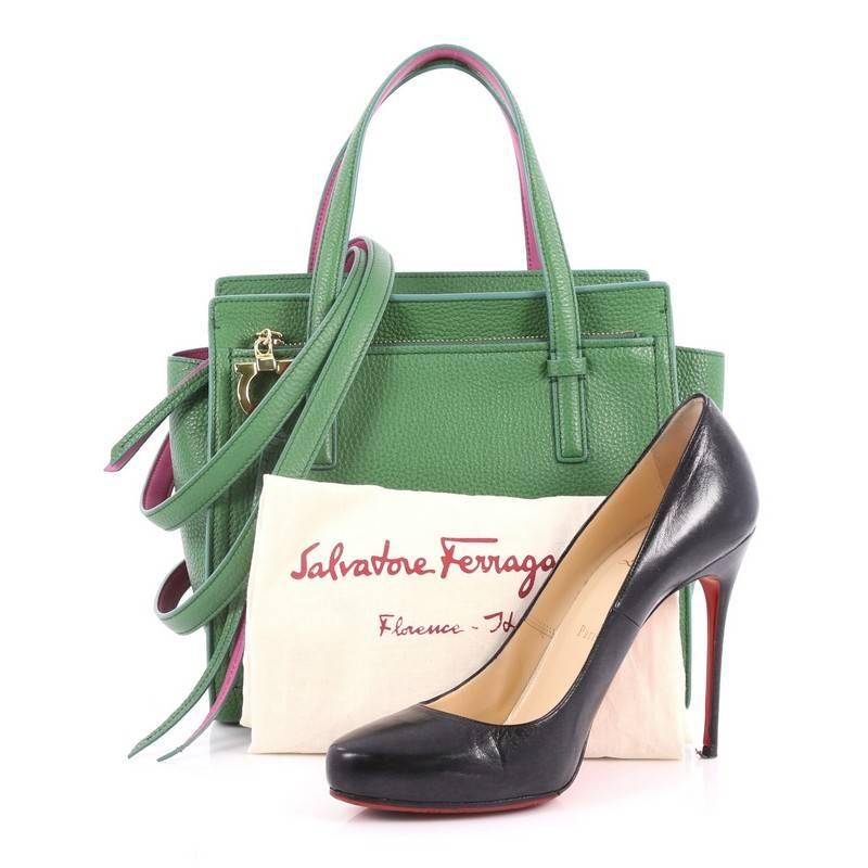 This authentic Salvatore Ferragamo Amy Tote Pebbled Leather Mini is a stylish everyday bag. Crafted from green pebbled leather, this timeless tote features dual flat handles, exterior front zip pocket with Gancio charm zip pull, Salvatore Ferragamo