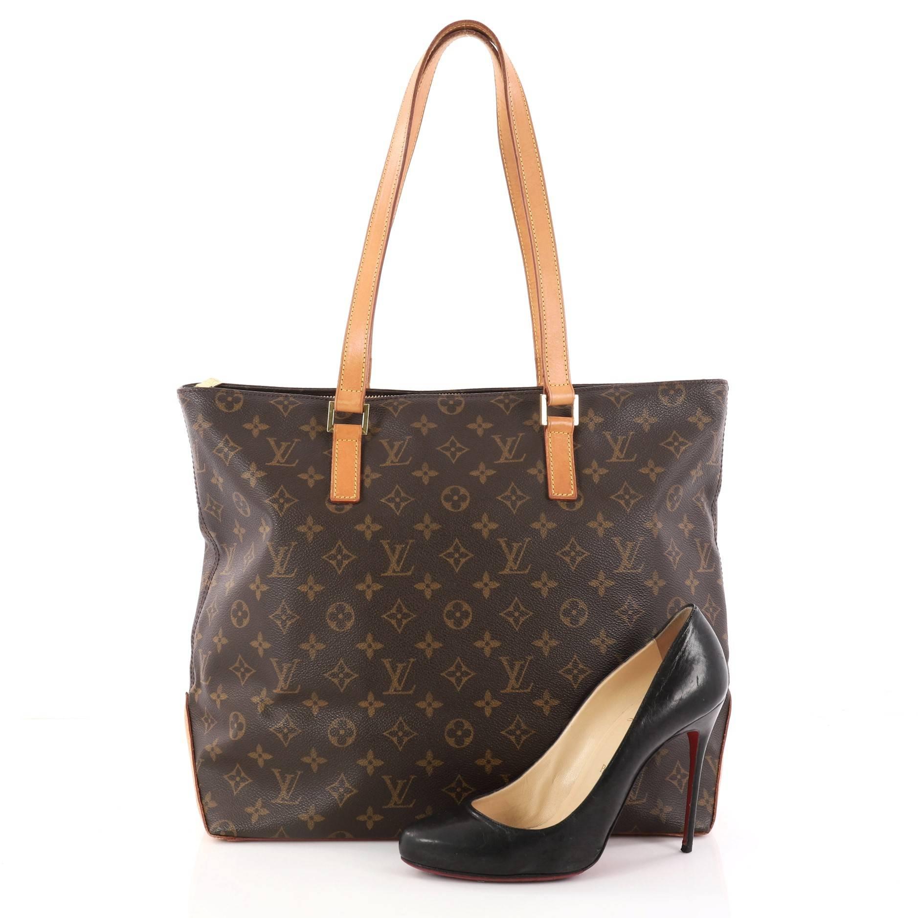 This authentic Louis Vuitton Cabas Mezzo Monogram Canvas is a marvelous tote that is ideal for everyday use. Constructed from Louis Vuitton's monogram coated canvas, this chic city tote features vachetta cowhide leather handles and base, and