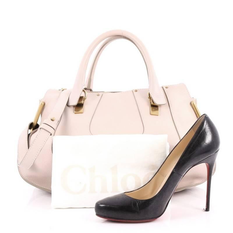 This authentic Chloe Hayley Satchel Leather Medium is a recent addition to Chloe's coveted handbag collection. Crafted from pale pink leather, this chic bag features dual-rolled leather handles, knotted leather shoulder strap and gold-tone hardware