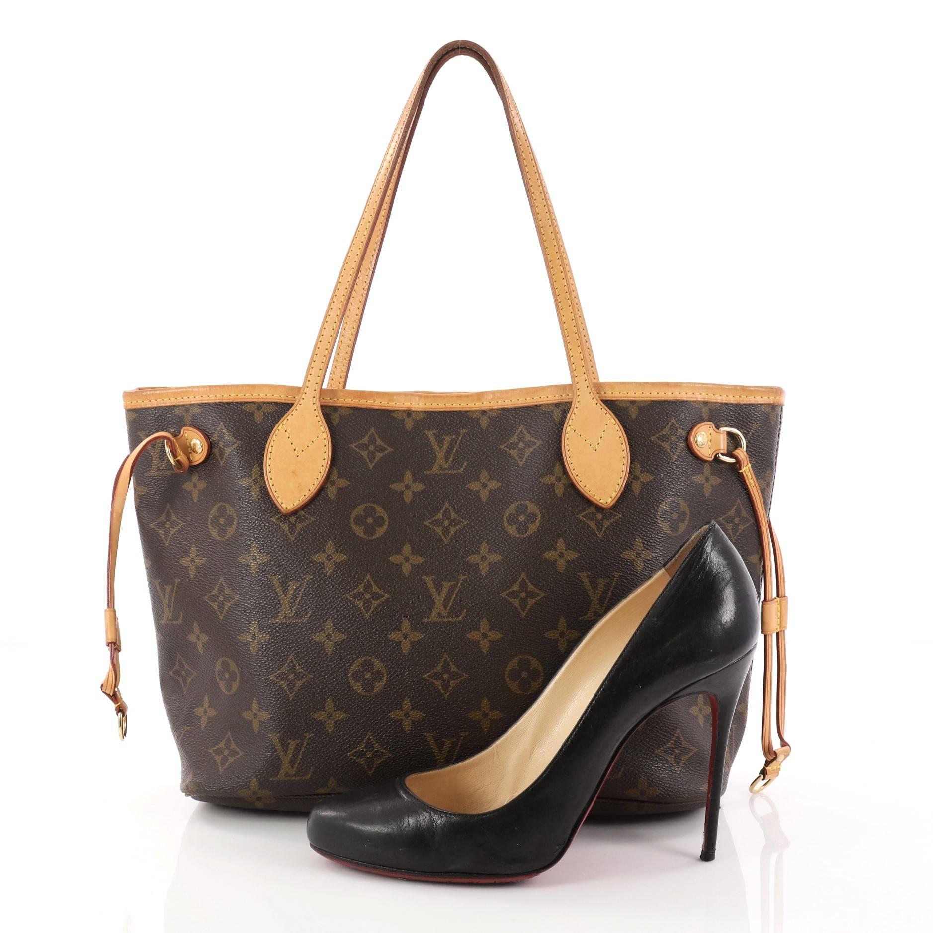 This authentic Louis Vuitton Neverfull Tote Monogram Canvas PM is a perfect companion for daily excursions. Crafted from Louis Vuitton's signature brown monogram coated canvas, this iconic easy-to-carry bag features natural cowhide leather trim,
