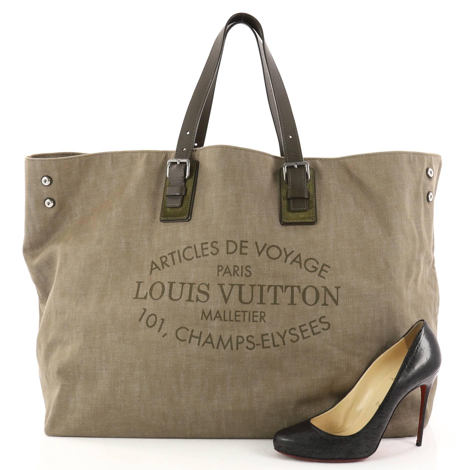 This authentic Louis Vuitton Limited Edition Articles de Voyage Cabas Denim XL is the perfect bag for your light travels. Crafted in brownish green denim with voyage lettering, this tote features adjustable dual leather handles, side snap buttons,
