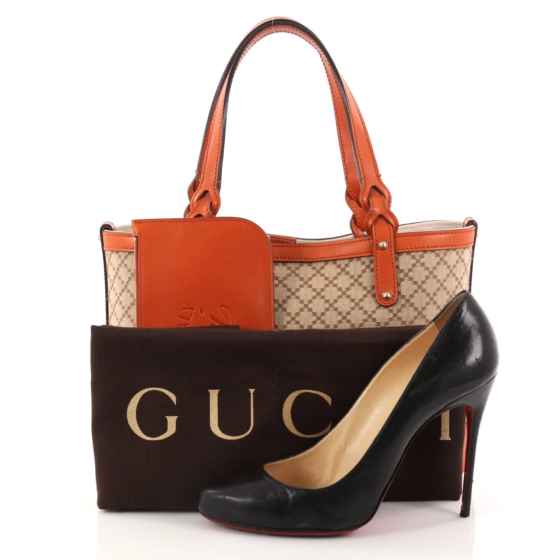 This authentic Gucci Craft Tote Diamante Canvas Small is casual and stylish perfect for everyday use. Crafted from brown diamante canvas with orange leather trims, this tote features dual-flat handles with braided ends and gold-tone hardware