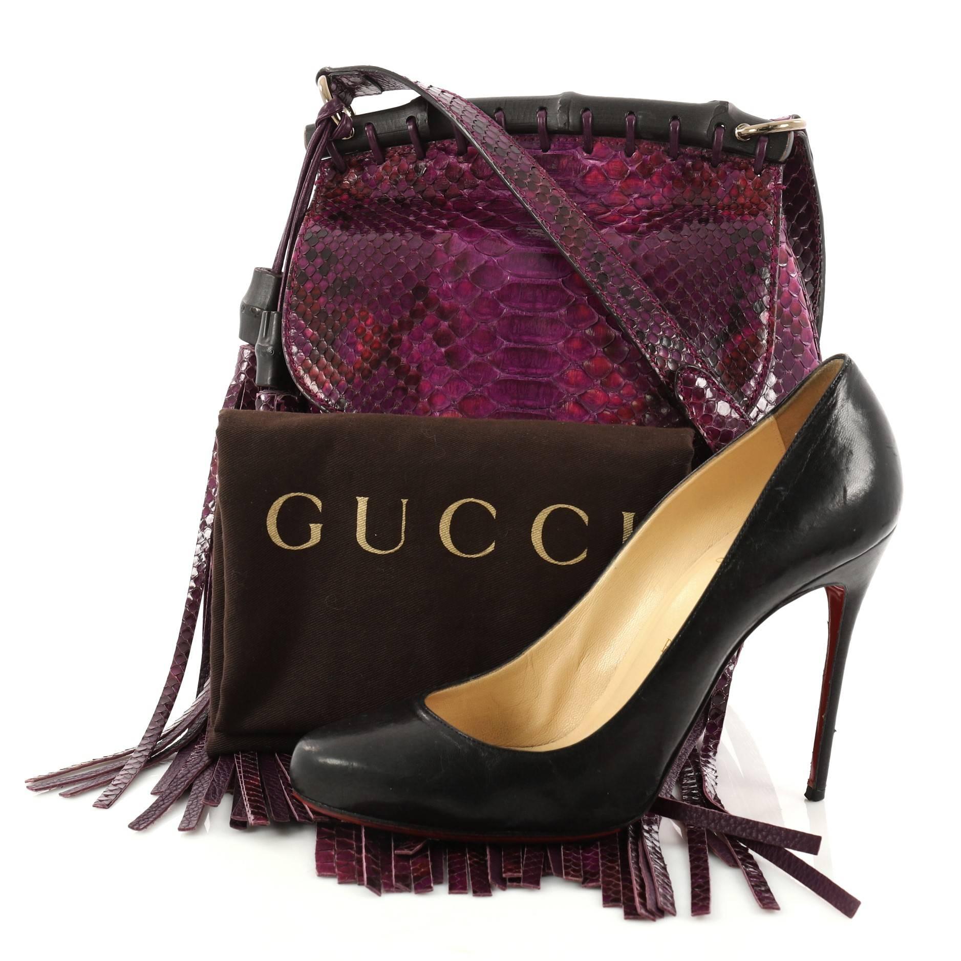 This authentic Gucci Nouveau Fringe Crossbody Bag Python Small mixes boho-inspired style with classic Gucci detailing. Finely crafted in beautiful genuine purple python skin, this crossbody features adjustable shoulder strap, a black lacquered