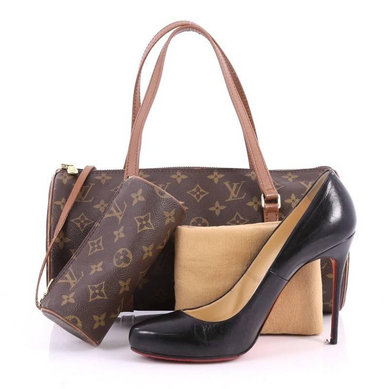 This authentic Louis Vuitton Papillon Handbag Monogram Canvas 30 is a classic for LV lovers. Crafted in its signature brown monogram coated canvas, this rounded bag features vachetta leather trims, dual flat vachetta leather handles and gold-tone