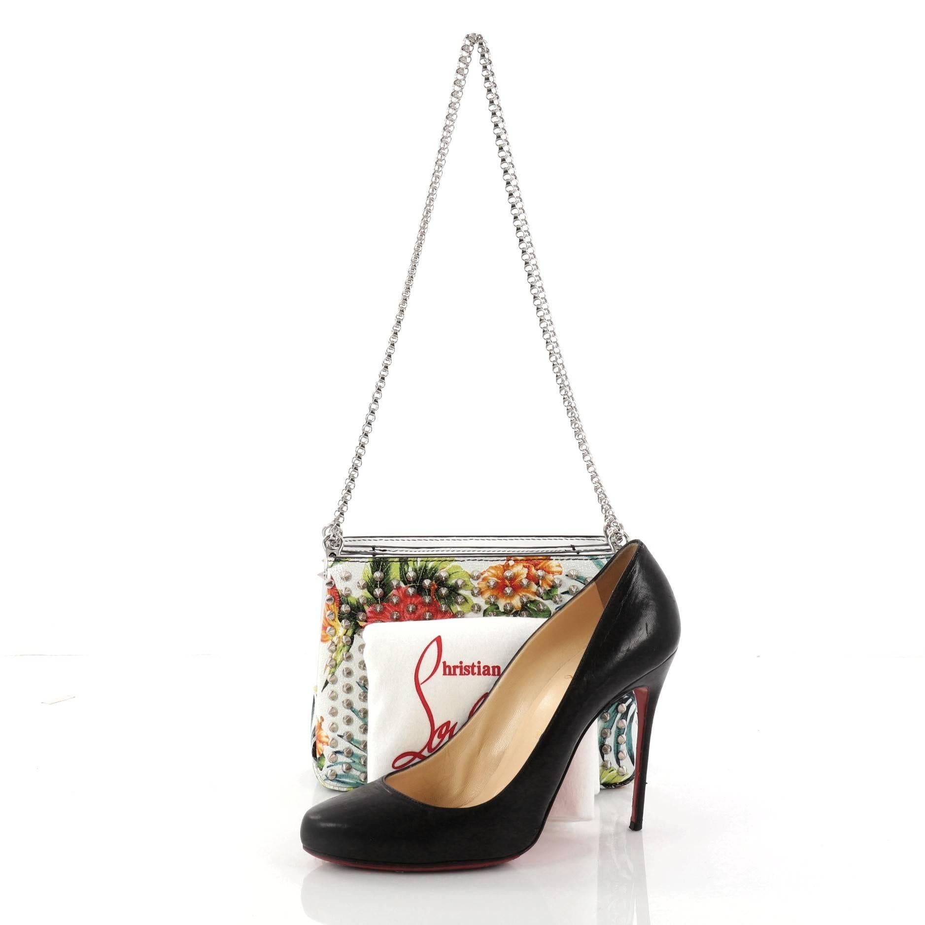This authentic Christian Louboutin Triloubi Chain Bag Printed Leather Small balances an edgy-chic design with feminine flair perfect for nights out. Crafted in white floral printed leather, this day-to-night chain bag features Louboutin's signature