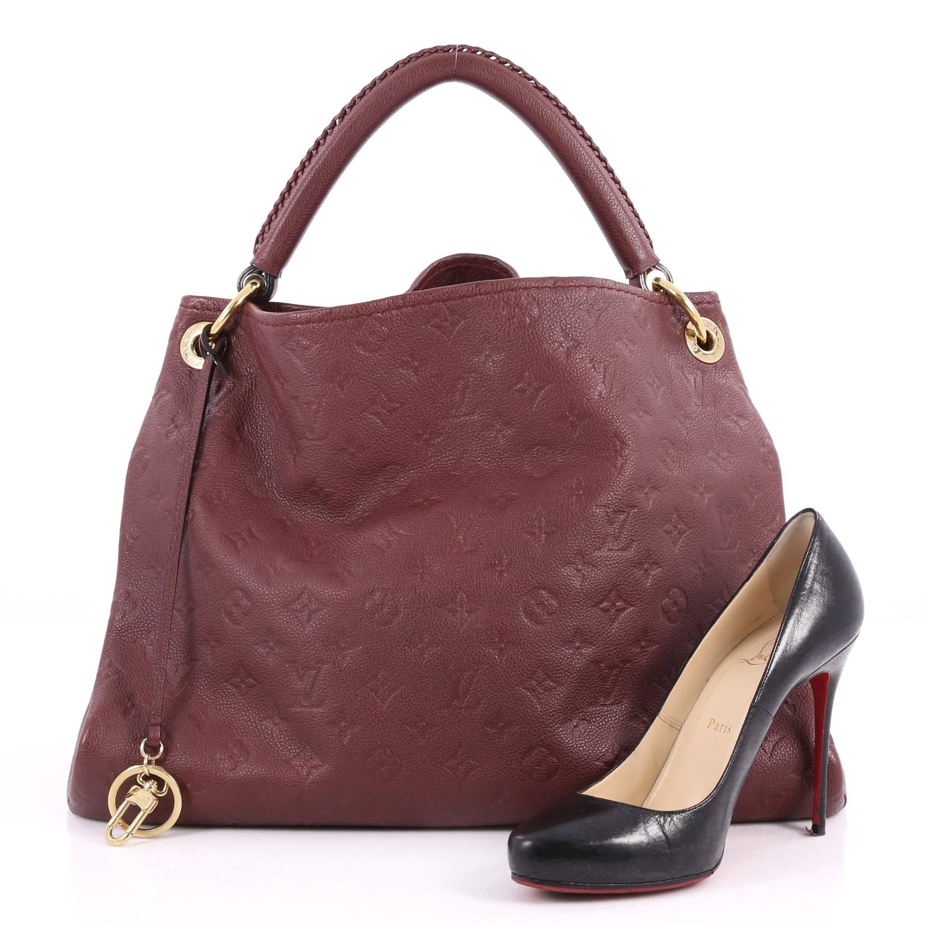 This authentic Louis Vuitton Artsy Handbag Monogram Empreinte Leather MM is an iconic hobo. Crafted from burgundy monogram embossed empreinte leather, this luxurious and refined hobo features a single looped braided top handle with polished gold