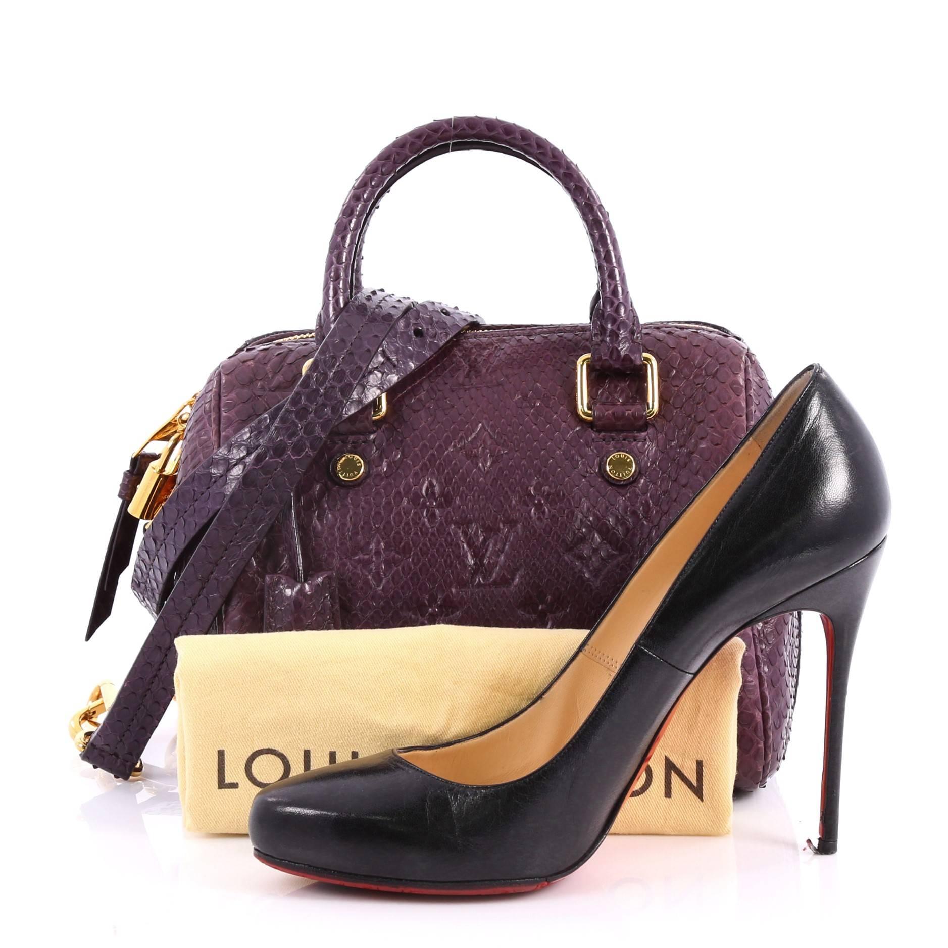 This authentic Louis Vuitton Speedy Bandouliere Bag Monogram Embossed Python 20 is a modern must-have. Constructed from luxurious purple monogram embossed python skin, this iconic and re-imagined Speedy features dual-rolled leather handles, and